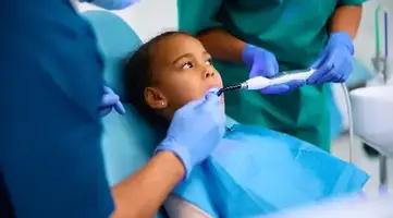 Young girl receiving gentle dental care