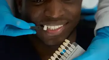 Doctor selecting dental veneers for a patient